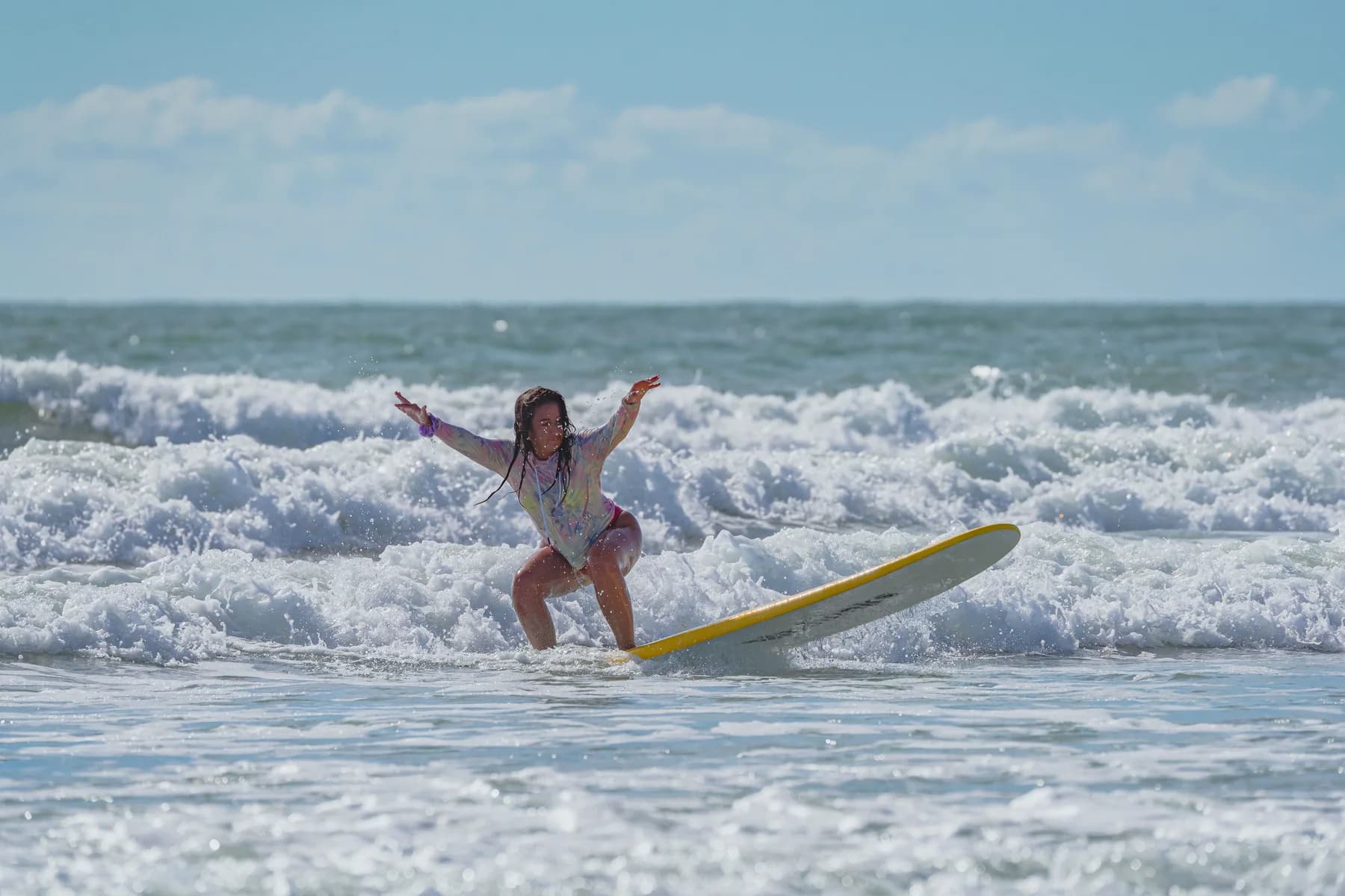 A surfer riding a wave on a longboard