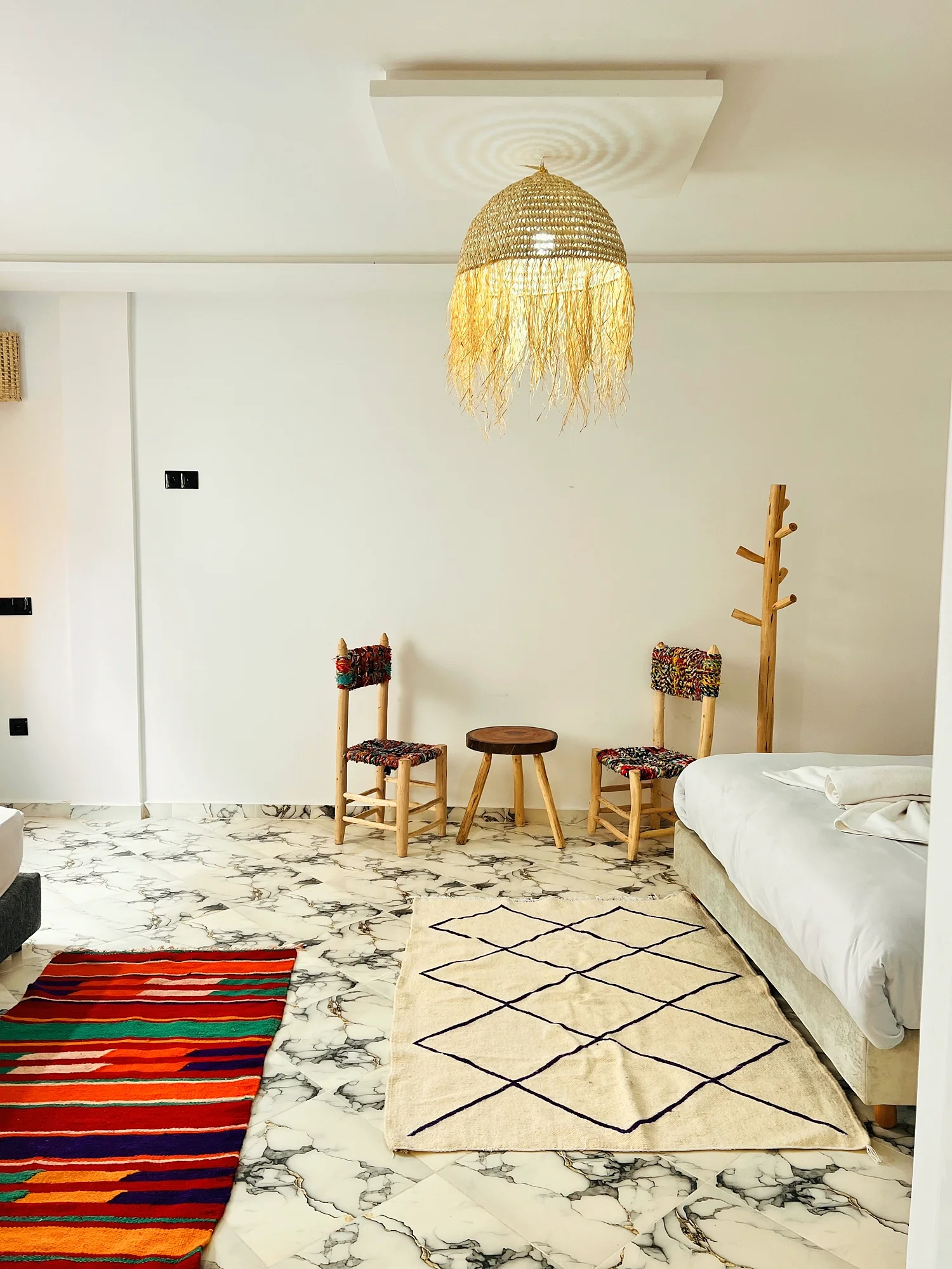 Inside a bright White Pearl suite, marble floors and natural light