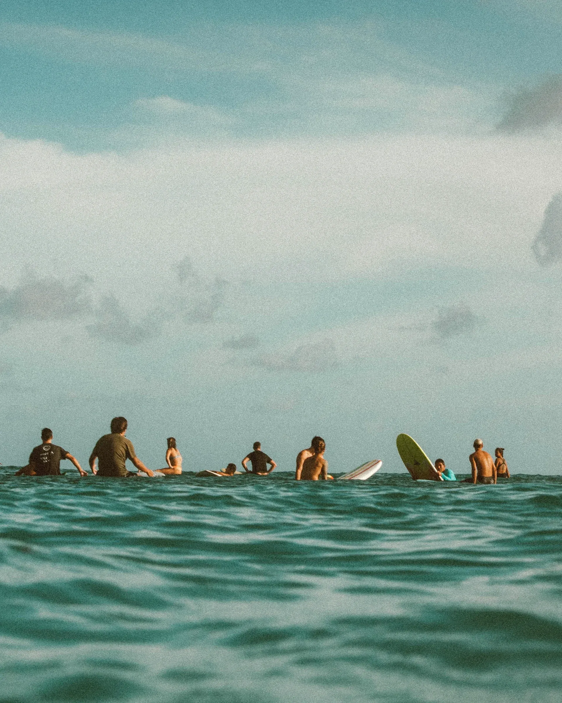 Surfers sharing a wave in turquoise water